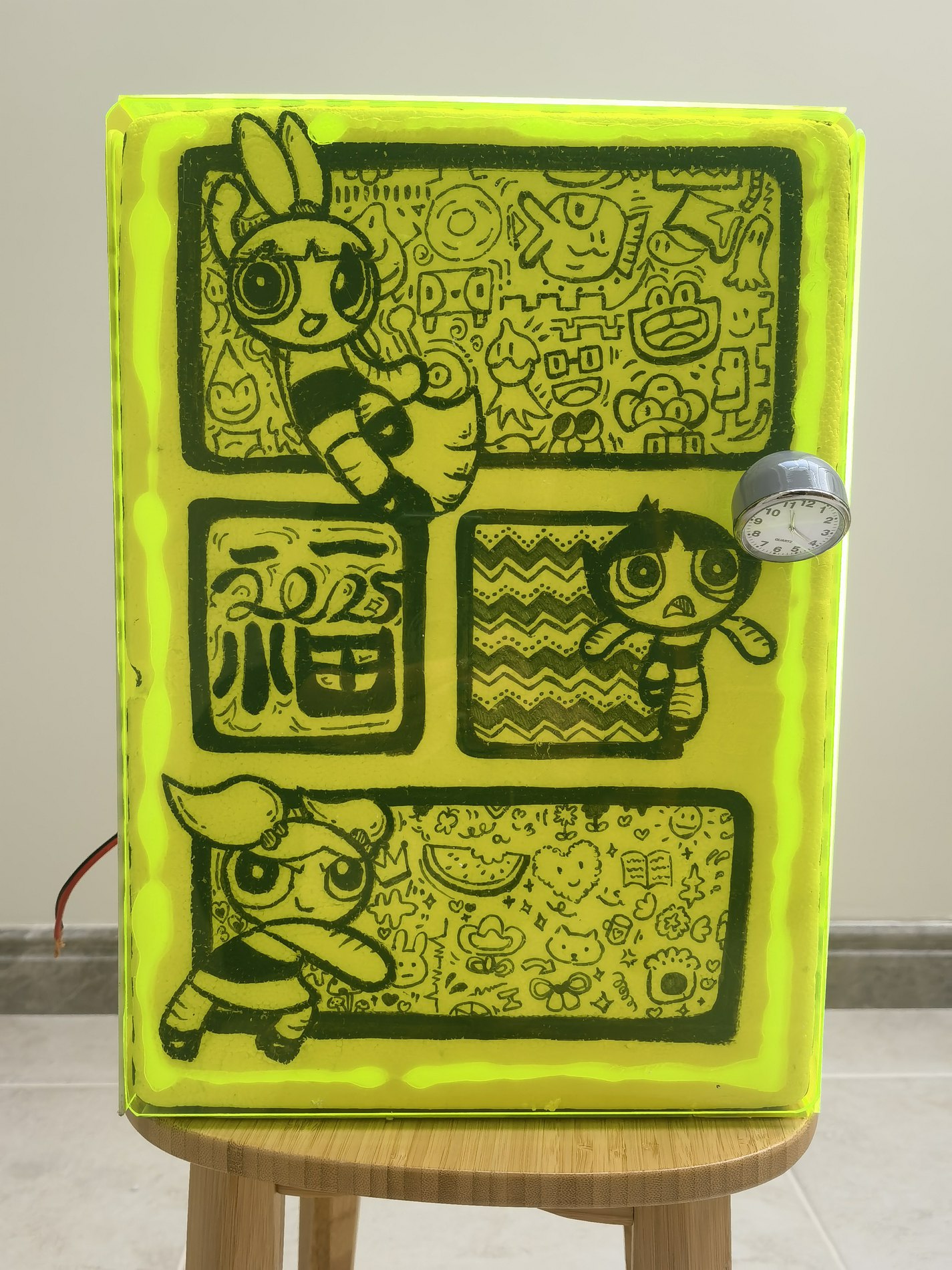 A handmade portable fridge with a hand-painted yellow-green shell
