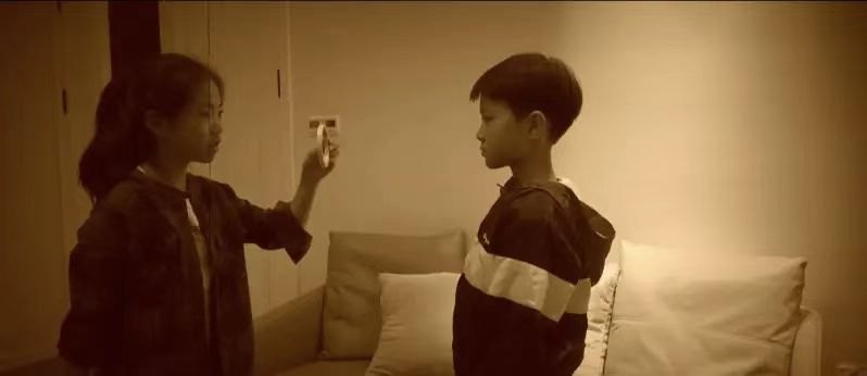 Still from the micro-film Fangfang's World, two children facing each other