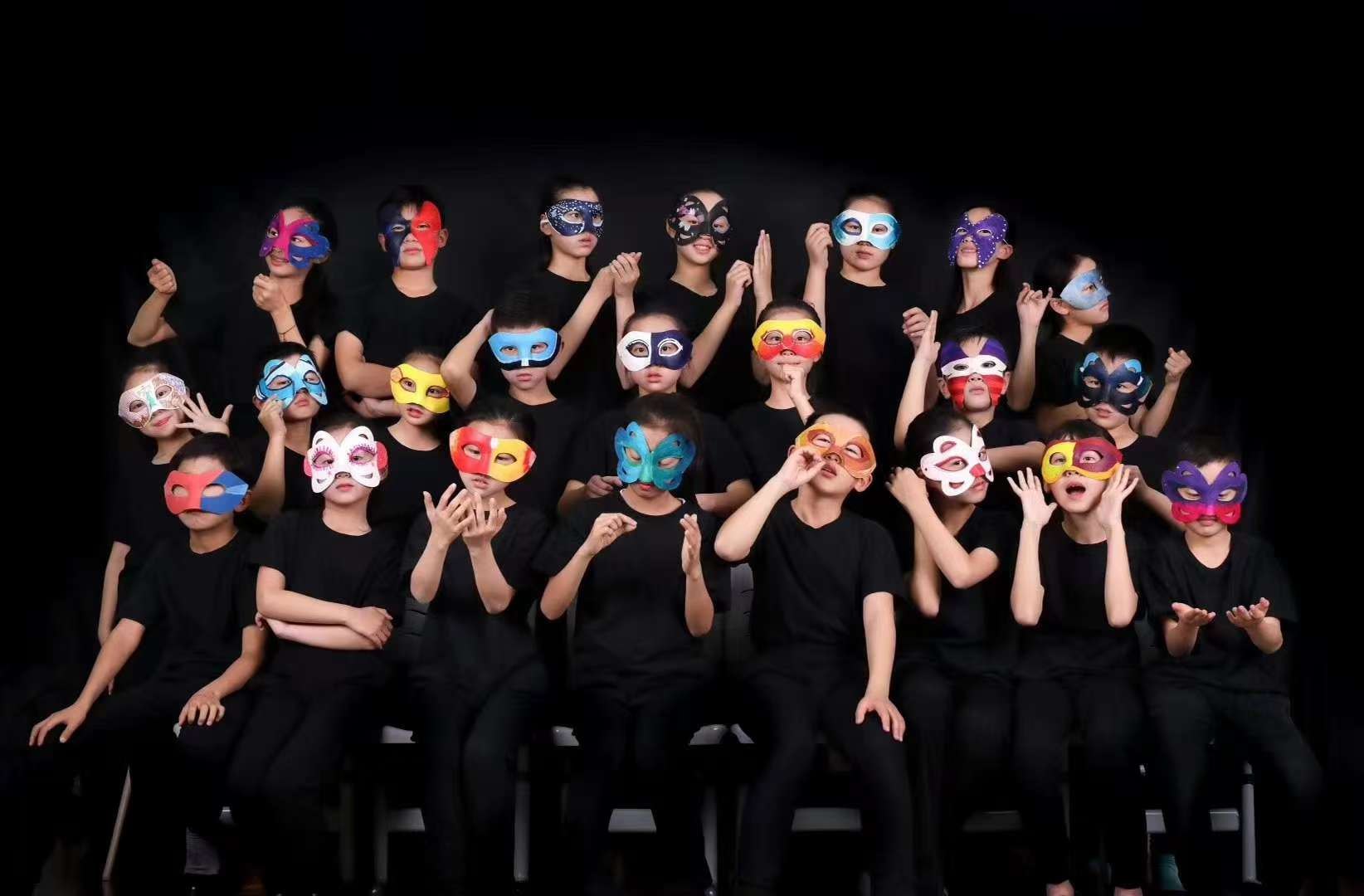 Ensemble portrait in masks against a black background