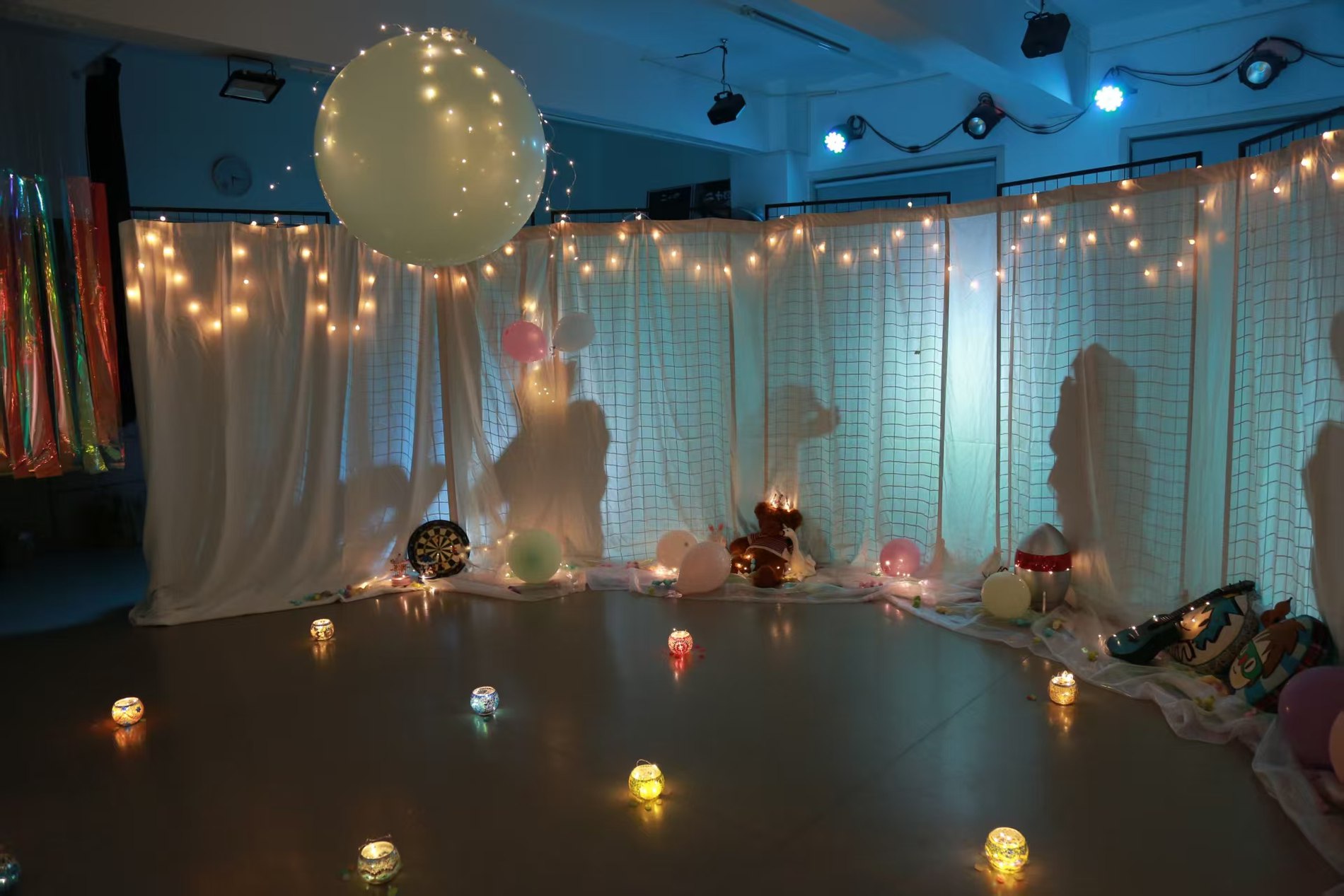 Immersive installation room strung with lights and floating orbs