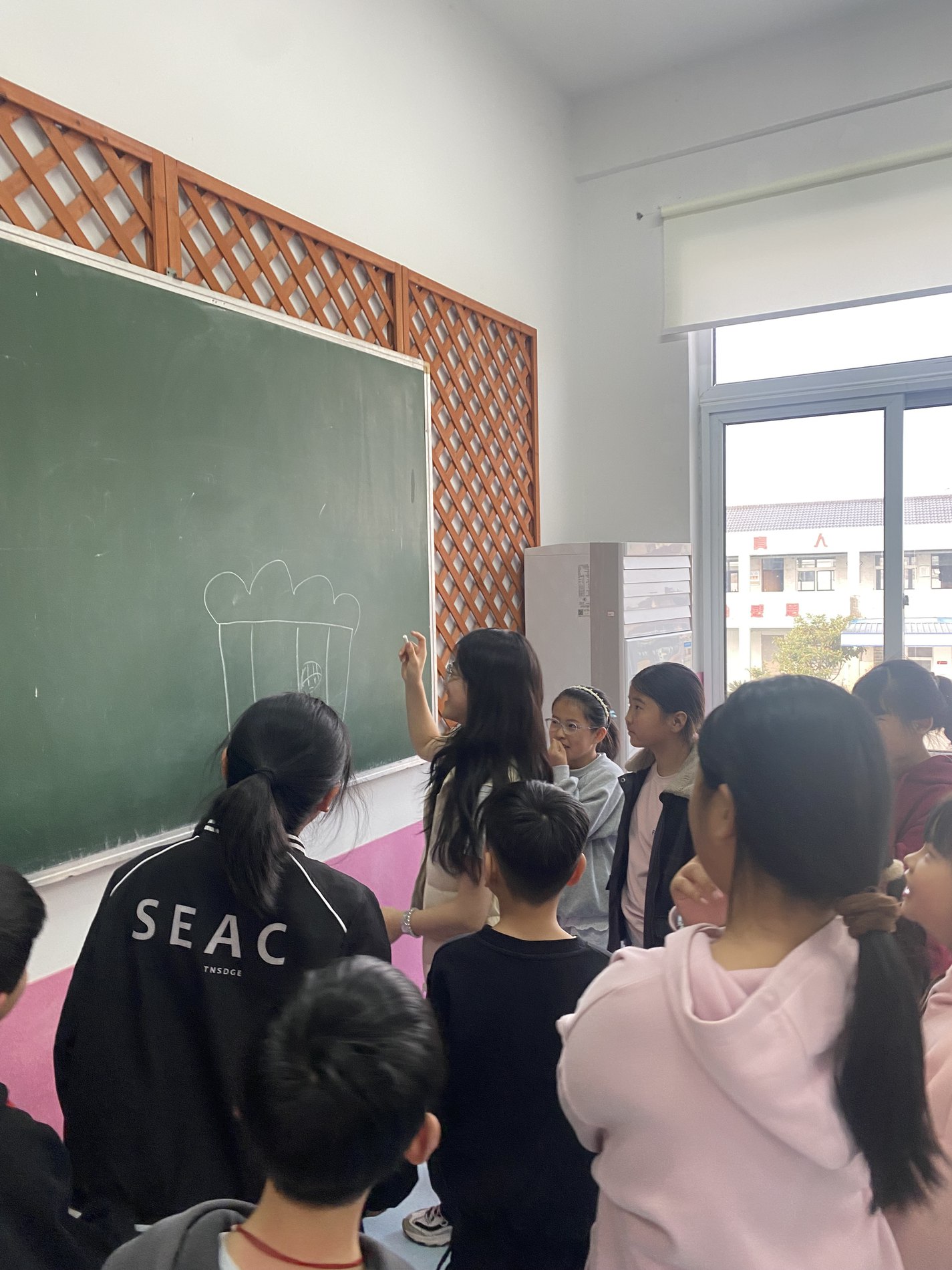 HOPE gender education session, students facing a classroom chalkboard