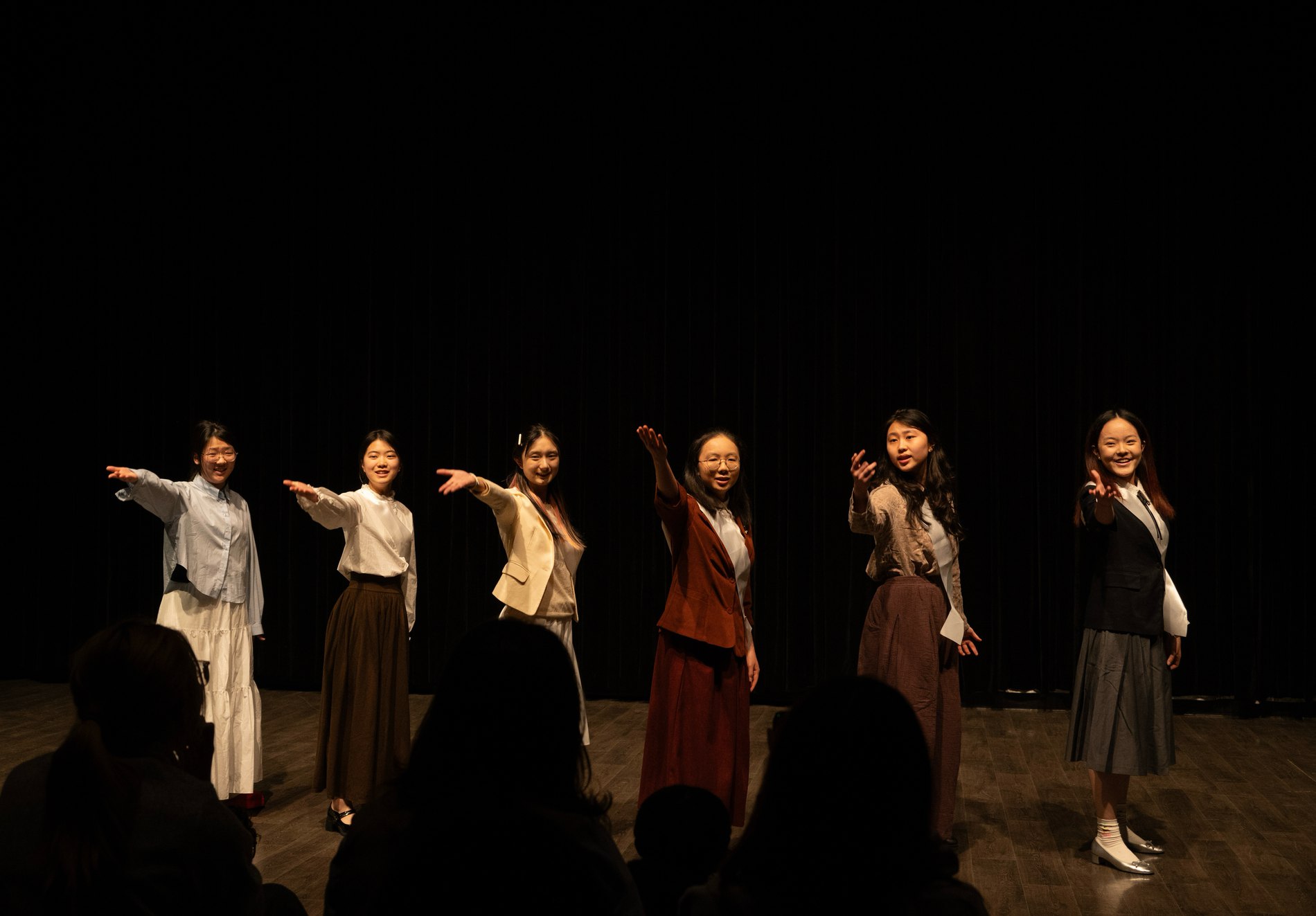 Dance ensemble in flowing costumes on stage
