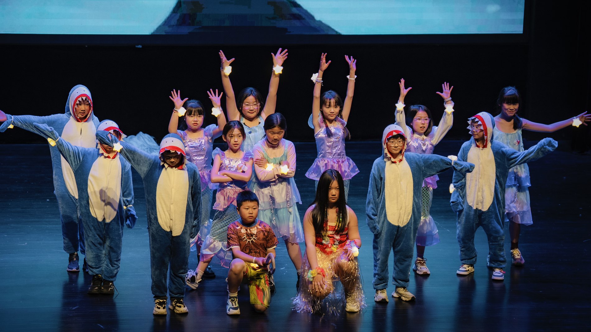 Sintillate musical performance, students in animal costumes on stage