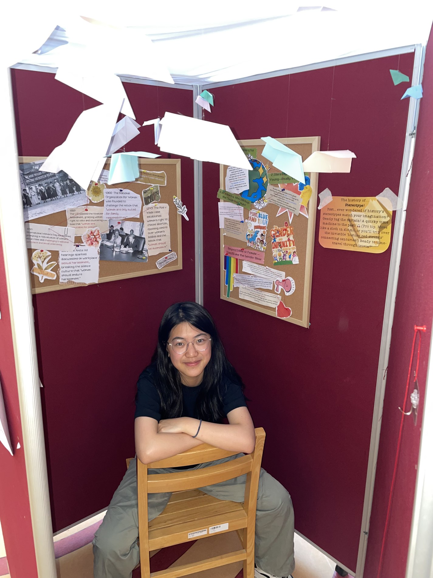 Sitting at an exhibition booth with a presentation board