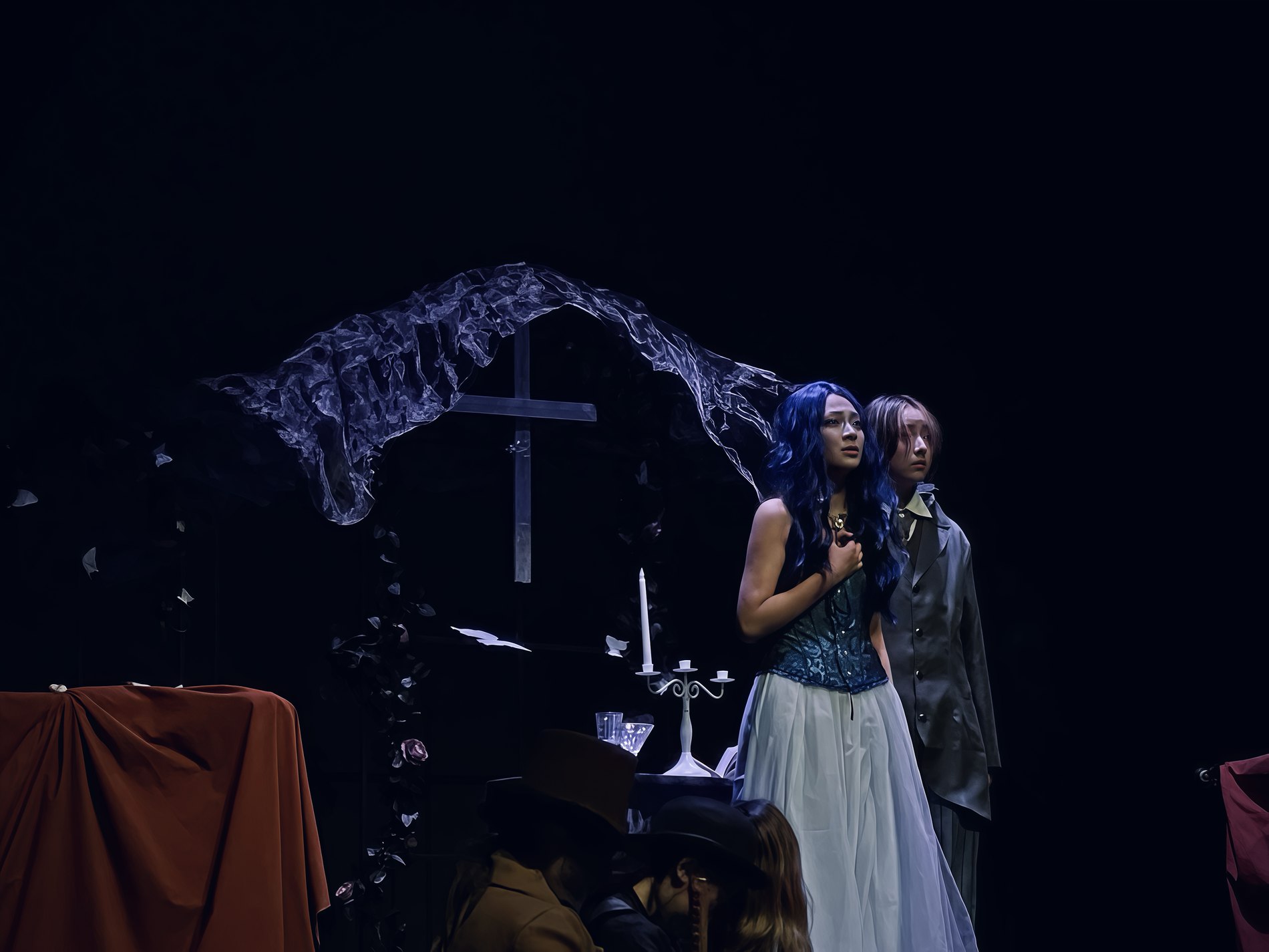 Gothic wedding altar set piece built for the production Corpse Bride, lit in purple with falling paper butterflies